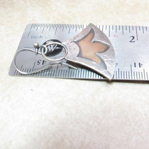 Mixed metal lotus earrings displayed against ruler to show length at apx. 1.5" long.