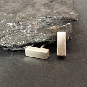 Sleek little bar stud earrings crafted in sterling silver. Chunky little bars perfect as a unisex design. Bar measures 3mm x 10mm and are completed with clutch backs to hold them securely in place. A simple, modern design perfect for all sexes.