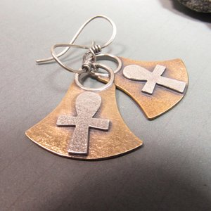 Bronze and silver ankh earrings. Body of earring shaped similar to the egyptian lotus motif with ankh on the front, suspended by silver ring and ear wires. 1.5" tall and 1" wide at widest point.  Displayed on grey background.