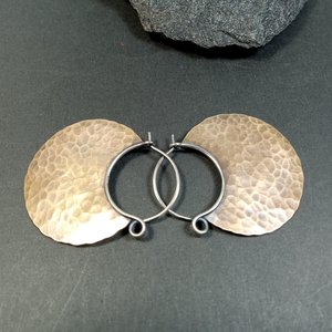 Side view of bronze hoops highlighting unique spring closure.