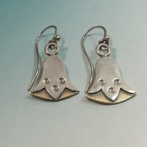 Mixed metal bronze and sterling silver egyptian lotus earrings by Mocahete on blue background