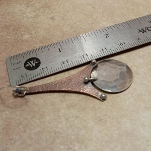 Copper and argentium earrings displayed against ruler to show size.