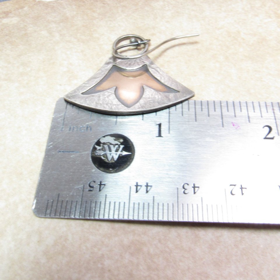 Lotus earrings in mixed metals displayed against ruler to show size. Apx. 1.25" wide.