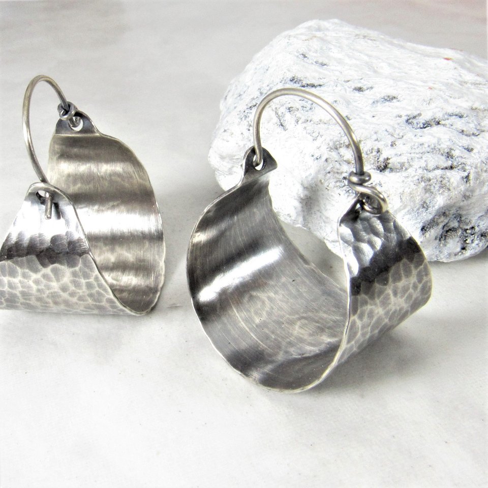 Rustically classic elegance in a pair of handcrafted hammered and oxidized sterling silver basket hoop earrings. The hammered surface catches the light beautifully. So very versatile with their soulful boho energy. 1 and 3/8 inch tall x 1 inch wide