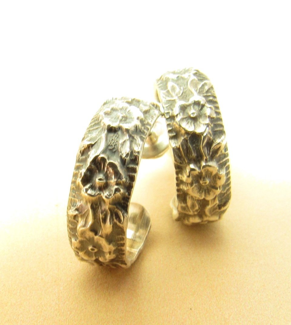 Small rose pattern sterling silver hoops with post backs. Lovely, romantic pattern in an extra small hoop earring. 5/8 inch wide and tall. Oxidized to enhance the pattern and add a bit of antique appeal.