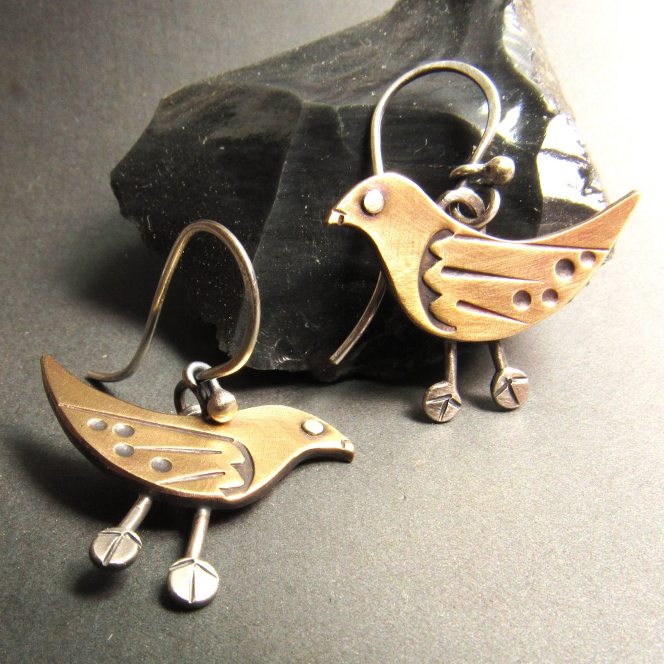 Whimsical and unique bird earrings in sterling silver and bronze. Great details add up to a bohemian inspired look for those that love art jewelry. 1 inch tall x 1 inch wide.