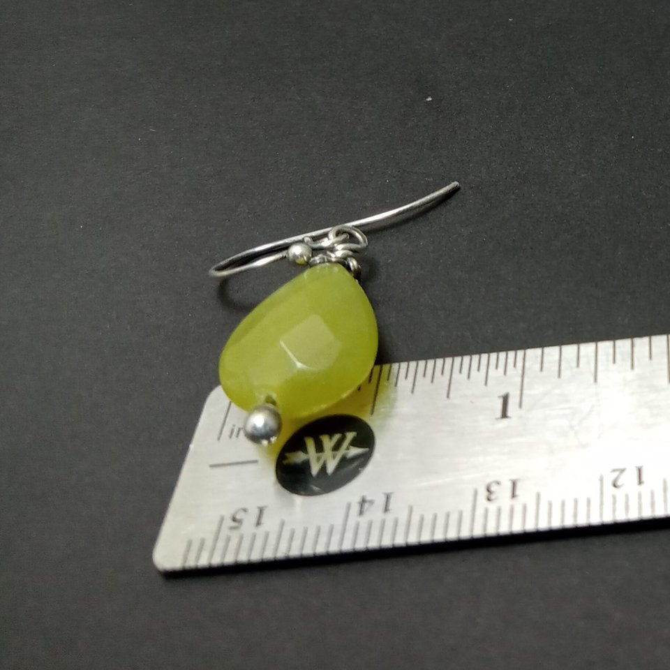To show width these serpentine and silver dangle earrings photographed against ruler.
