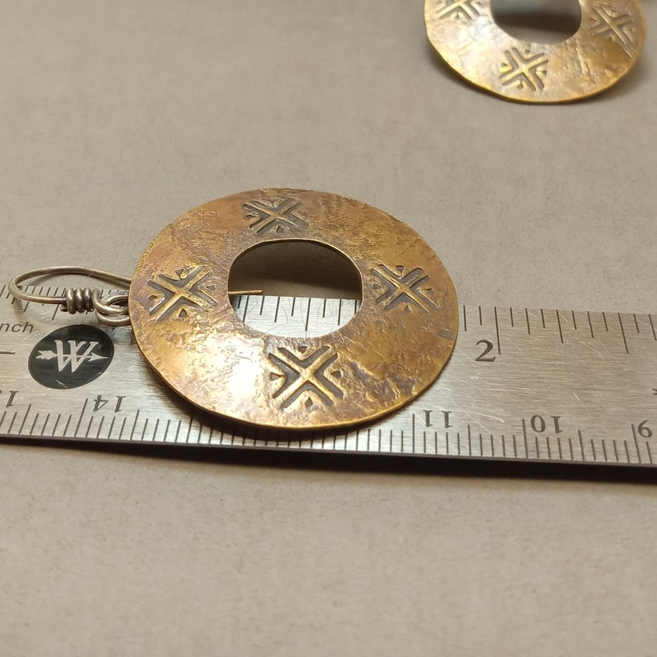 Mixed metal ancient coin style earrings against ruler to show size.