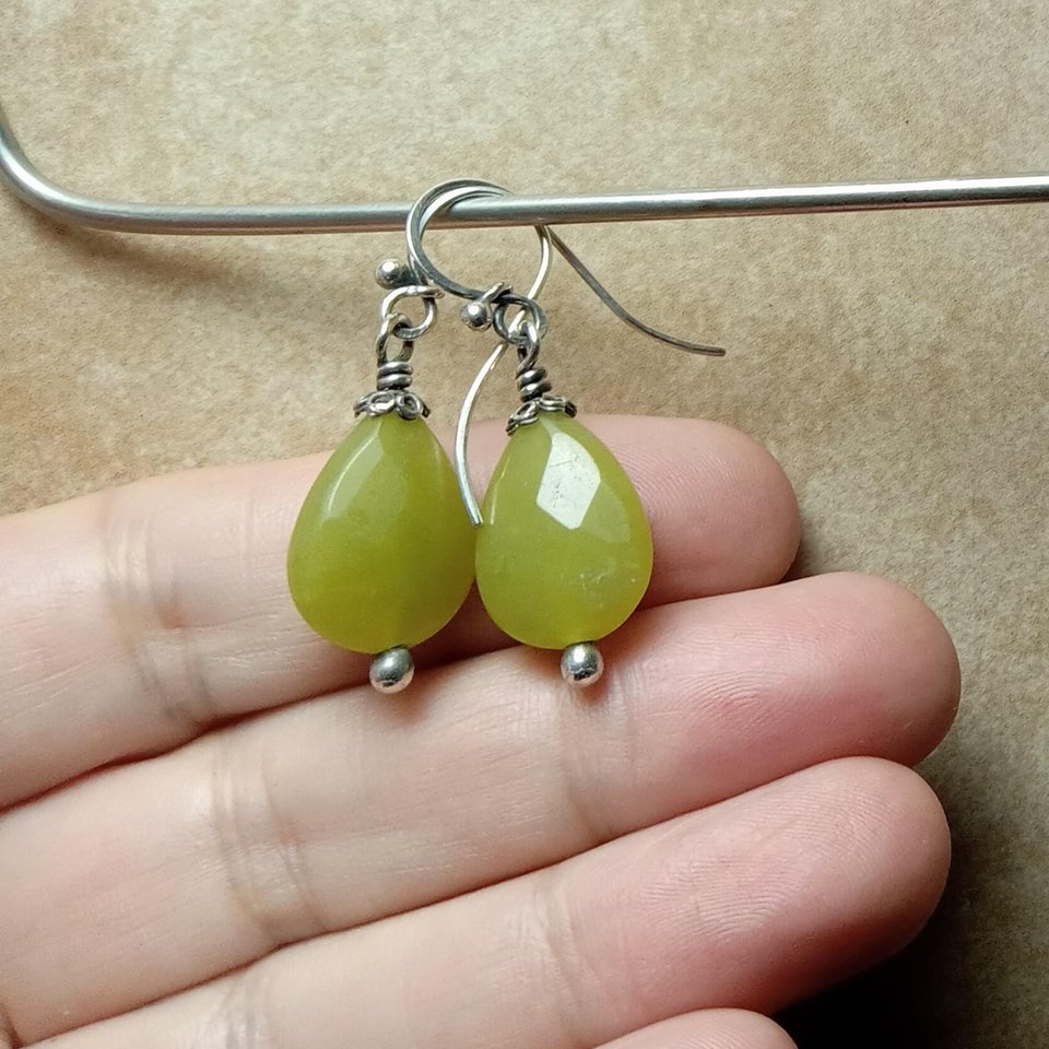 Serpentine dangle earrings in hand.