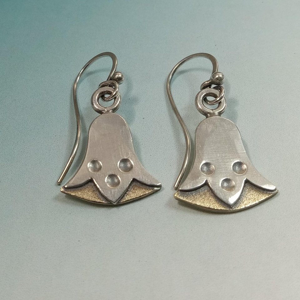 Mixed metal bronze and sterling silver egyptian lotus earrings by Mocahete on blue background