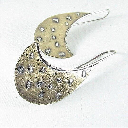 Jazz, a swoop of sand textured bronze with fused bits of sterling silver and a long elegant sterling silver ear wire are a unique and interesting pair of avant garde earrings that are lightweight. 2.25" long1 and 1/8" wide at widest point