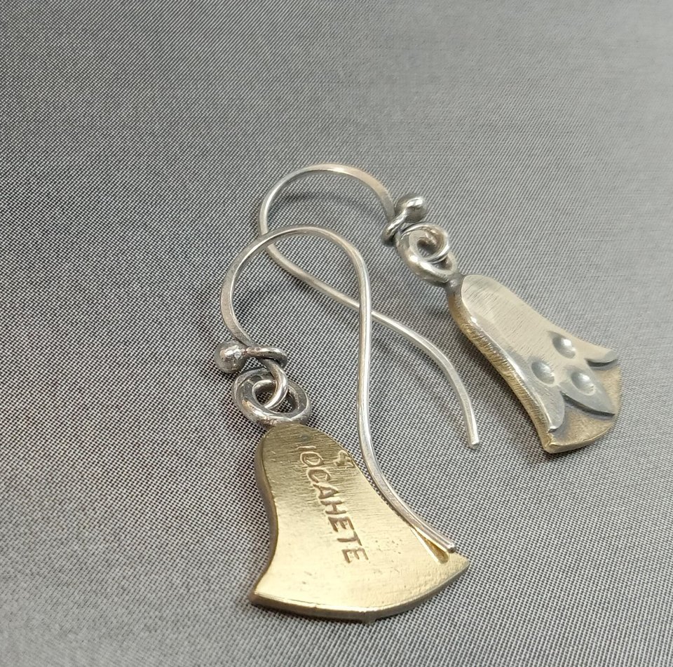 makers mark view of mixed metal bronze and sterling silver egyptian lotus earrings by Mocahete on grey background