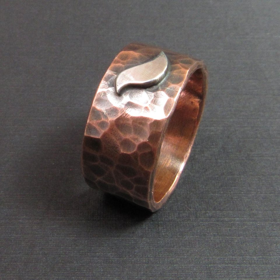 Hammered copper wide band ring with SS bird, photo on dark background.