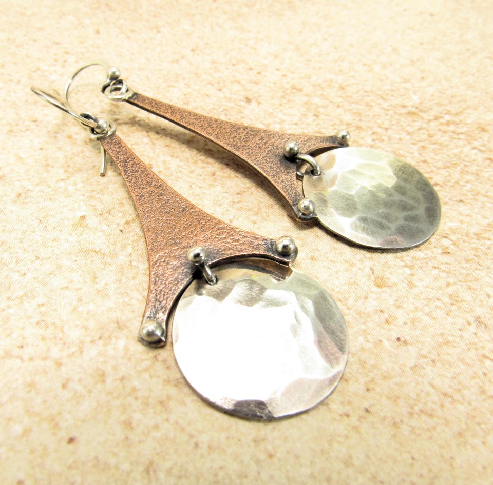 Geometric Eiffel tower earrings, mixed metals, copper, silver. Displayed on neutral background.