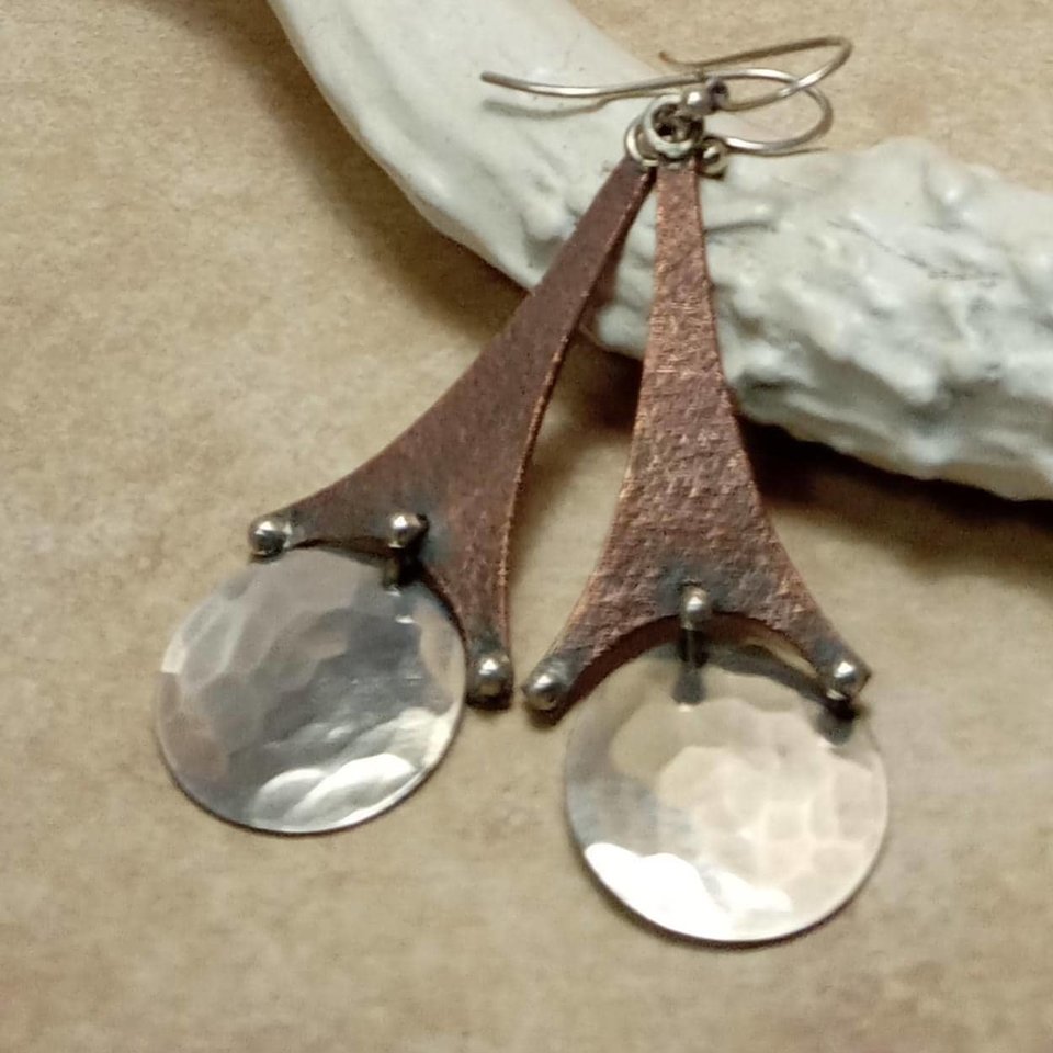 Mixed metal earrings, unique Eiffel tower design. Displayed against antler.