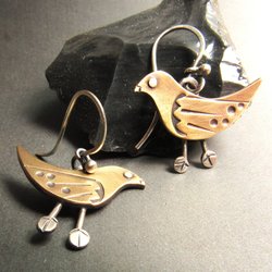 Whimsical and unique bird earrings in sterling silver and bronze. Great details add up to a bohemian inspired look for those that love art jewelry. 1 inch tall x 1 inch wide.