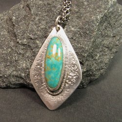Stunning turquoise from the number 8 mine is set on a textured argentium sterling silver backplate in an organic geometric shape, Pendant is 1.75 inch long, a touch over 1 inch wide at widest point. The chain is sterling silver and measures 20 inch